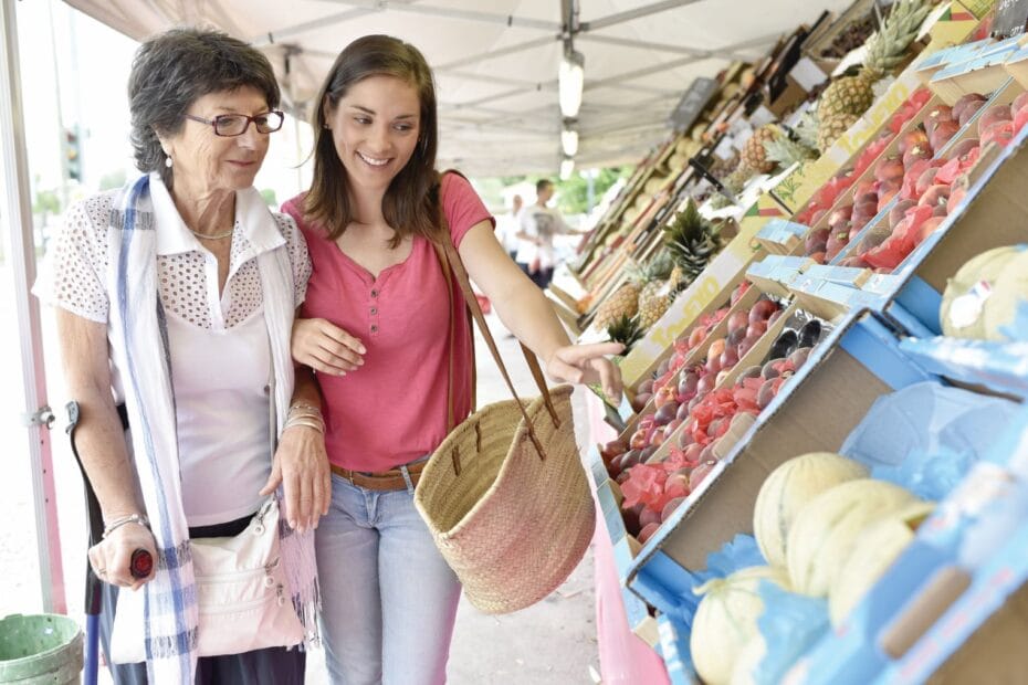 Elder woman shopping with female carer.